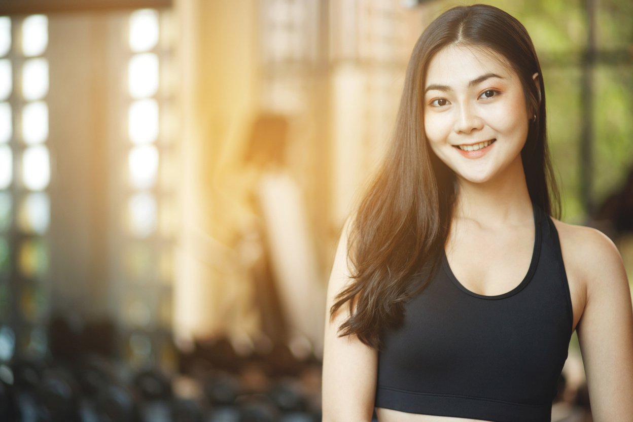 Asian woman exercising to lose weight at the gym